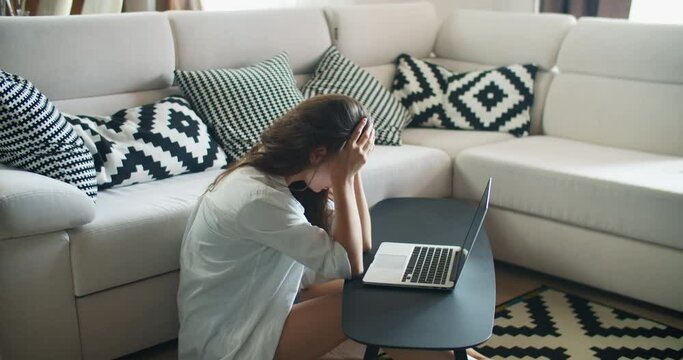 Tired Woman Working At Home On A Laptop. Finishes Work And Does Manual Massage Voices. Strong Tired After A Working Day
