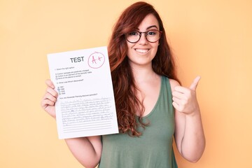 Young beautiful woman showing a passed exam smiling happy and positive, thumb up doing excellent and approval sign