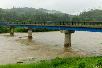 大雨で増水した川　橋　濁流