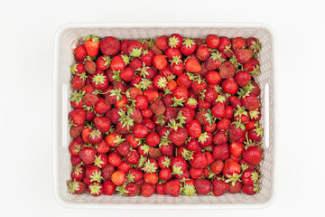 plastic beige box with strawberries on a white background, view from above