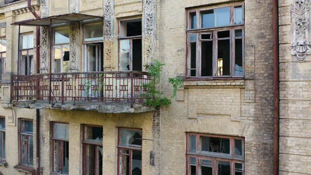 Abandoned old commercial apartment building in the Art Nouveau style (Modern Style) with a broken windows. Deserted early 20th century house. Aerial side view
