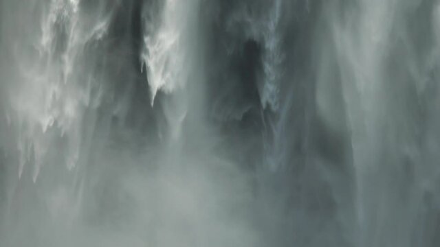 Slow motion cinematic waterfall mist Skogafoss Iceland