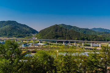 Railroad bridge in rural landscape.