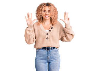 Young blonde woman with curly hair wearing casual winter jumper showing and pointing up with fingers number nine while smiling confident and happy.