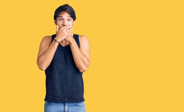 Handsome hispanic man wearing casual clothes shocked covering mouth with hands for mistake. secret concept.