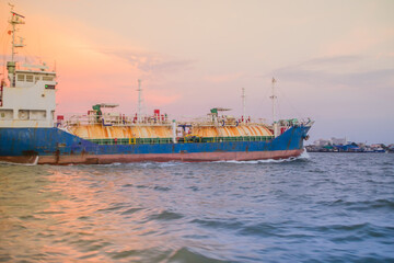 Obraz premium Massive container ship for import export and business logistic. Big cargo ship is leaving from Bangkok Port Authority of Thailand or Klong Toey port along Chao Phraya river in Bangkok,Thailand.