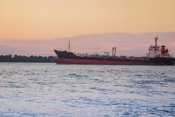 Massive container ship for import export and business logistic. Big cargo ship is leaving from Bangkok Port Authority of Thailand or Klong Toey port along Chao Phraya river in Bangkok,Thailand.