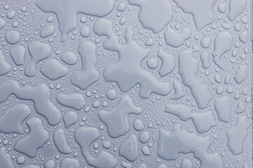 drops of rain water on toop of blue outdoor tile