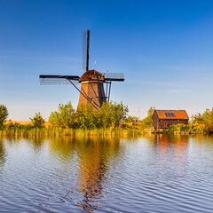 Netherlands Traveling. Traditional Dutch Windmill and House in Kinderdijk Village in the...