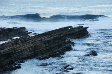 Waves on rocks in Orkney Islands Scotland. Photo for art decoration and blog story.