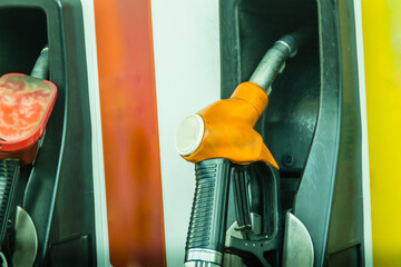 Yellow fuel oil dispenser at petrol filling station. Fuel dispensing pump at a gas station.