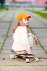 Obraz premium Youth and Teenagers Lifestyle. Portrait of Positive Caucasian Teenager Girl Posing With Longboard in Natural Outdoor Environment.