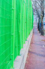 Perspective of green metal fence