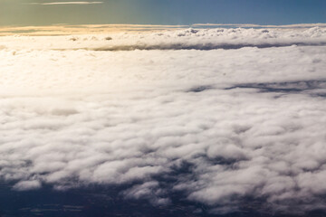Fototapeta na wymiar Beautiful cloudscape and blue sky from aerial view, nature view from above the sky and clouds. White clouds and blue sky view like the heaven from airplane window. Sunlight in the sky shines on clouds