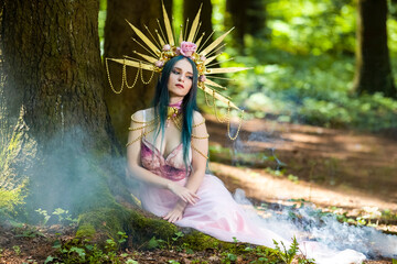 Costume Play. Magnificent Crowned Forest Nymph with Flowery Golden Crown Posing in Summer Empty...