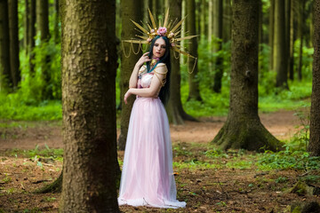 Costume Play Concepts. Sexy and Sensual Crowned Forest Nymph with Flowery Golden Crown Posing in...