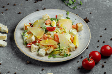 Caesar salad with salmon and fresh vegetables. Top view. Free space for your text