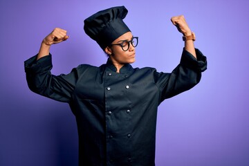 Young african american chef girl wearing cooker uniform and hat over purple background showing arms...