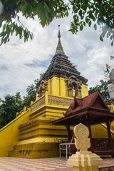 Fototapeta premium Beautiful golden Buddhist pagoda at Wat Phra That Doi Prabat (Wat Doi Phra Baht). Doi Phrabat Temple is the location of important historical sites and ancient religious in Chiang Rai, Thailand.