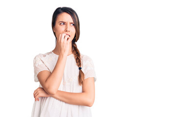 Fototapeta premium Young beautiful girl wearing casual t shirt looking stressed and nervous with hands on mouth biting nails. anxiety problem.