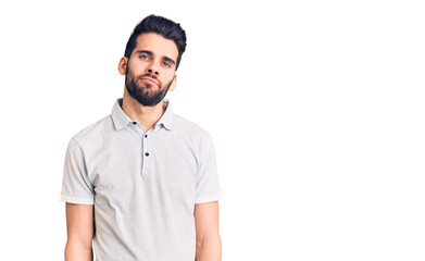Young handsome man with beard wearing casual polo relaxed with serious expression on face. simple and natural looking at the camera.