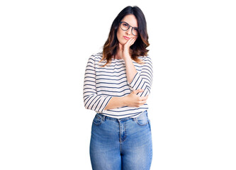 Beautiful young brunette woman wearing casual clothes and glasses thinking looking tired and bored with depression problems with crossed arms.
