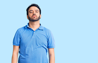 Fototapeta premium Young hispanic man wearing casual clothes relaxed with serious expression on face. simple and natural looking at the camera.