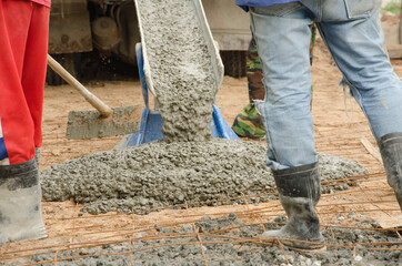 Fresh concrete leaning of the floor with iron grids