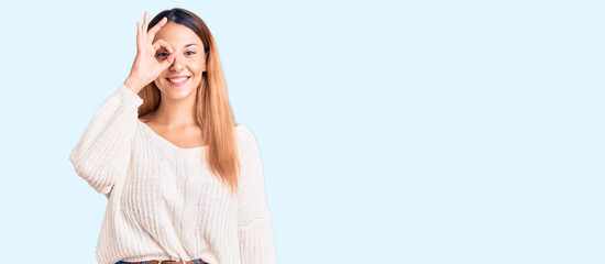 Beautiful young woman wearing casual clothes doing ok gesture with hand smiling, eye looking...