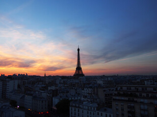 Fototapeta na wymiar Paris skyline with an impressive Eiffel Tower in the pleasant sunset sky.
