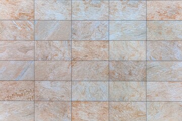Fototapeta premium Block pattern of Brown stone cladding wall tile texture and seamless background