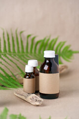 Blank amber glass essential oil bottles with craft package for branding mock up. Natural organic cosmetics, Alternative medicine, herbal essence, sustainable lifestyle concept