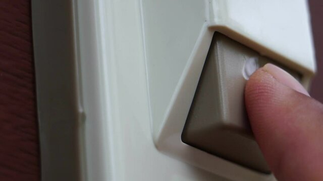 Footage Slow Motion: Male hand ringing a white electric doorbell insistentl