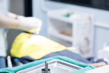 Blurred image photo of dentist  working in clinic.