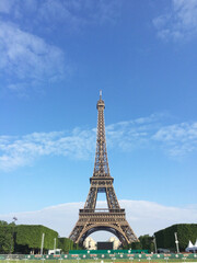 Fototapeta na wymiar Paris skyline with an impressive Eiffel Tower in the pleasant blue sky.