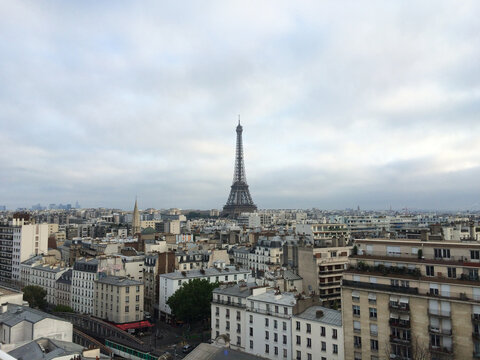 Paris skyline and Eiffel Tower on a cloudy day with thick clouds.