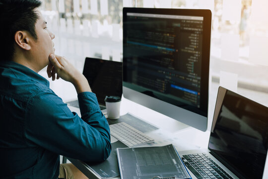 Asian man working code program developer computer web development working design software on desk in office.