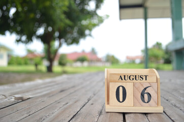 August 6, Number cube with a natural background.