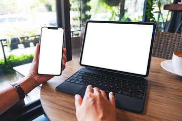 Mockup image of a woman using tablet pc with blank white desktop screen as a computer pc with...