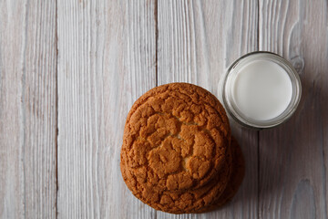 Tasty cookies and a glass of milk in a transparent glass on a white background