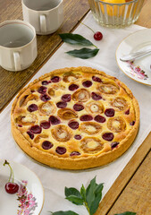 Fruit pie with sour cream filling, apricots and cherries