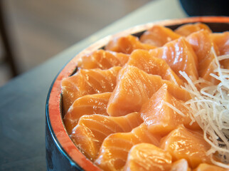 Fresh Sashimi Salmon Fillet In a Bowl. Japanese Dish with Vegetables, Selective focus.