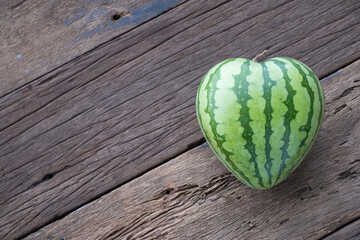 The heart shape of fruit water melon on wood background