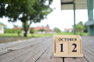 October 12, Number cube with a natural background.