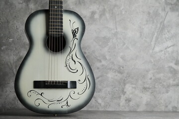 Vintage ladies antique guitar on a concrete base