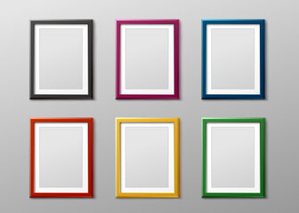 Colorful empty photo frame set hanging on grey wall - blank mockup