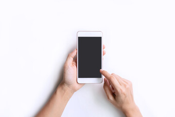 Top view studio shot hand using smartphone blank touch screen. Isolated on white background. Copy space