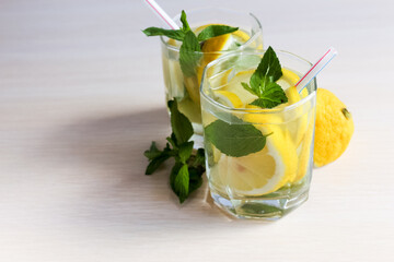 Lemonade or mojito cocktail with lemon and mint