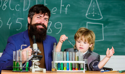 team of creators. bearded man teacher with little boy. father and son at school. Chemistry and physics biology. Back to school. Explaining biology to child. biotechnoloy research concept