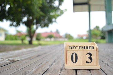 December 3, Number cube with a natural background.